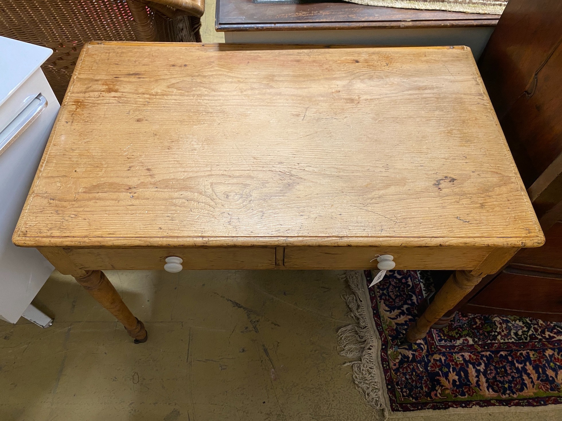 A late Victorian pine two drawer side table, width 92cm, height 74cm